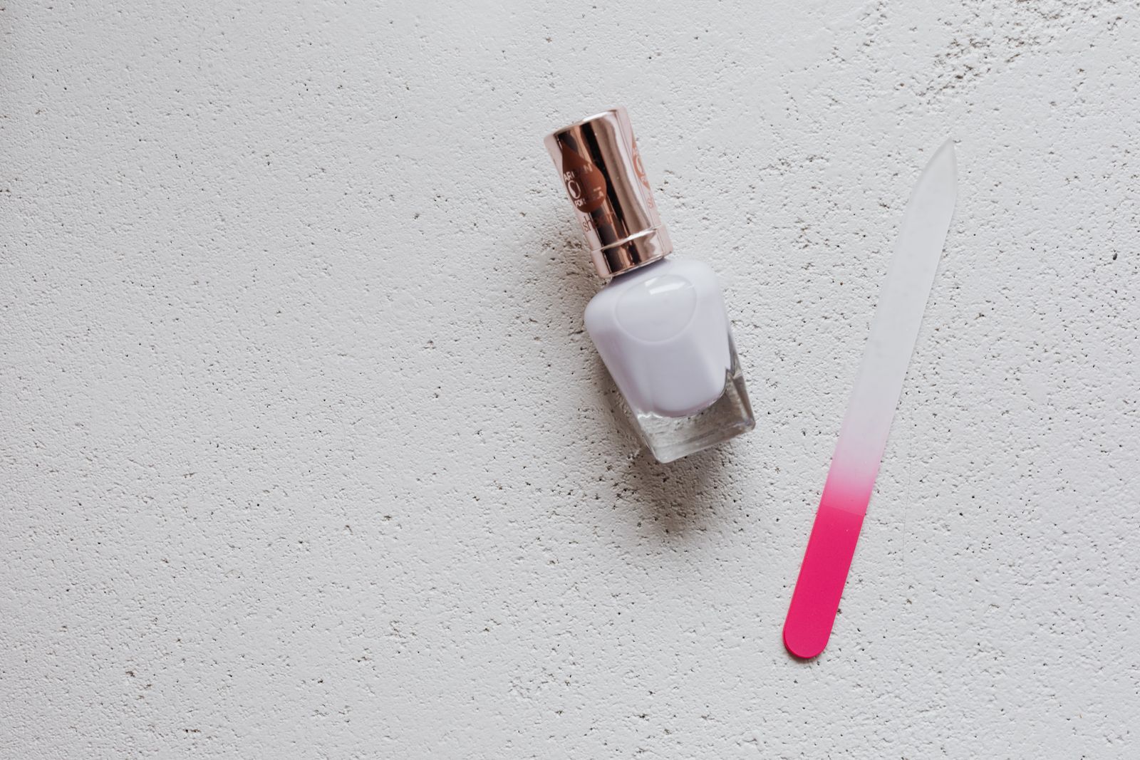 White polish and a pink glass nail file